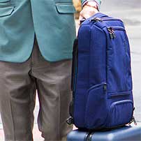 Man in a suit wearing a backpack