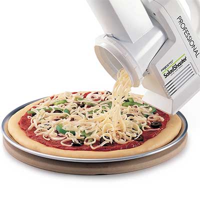 Electric appliance grating cheese on a pizza